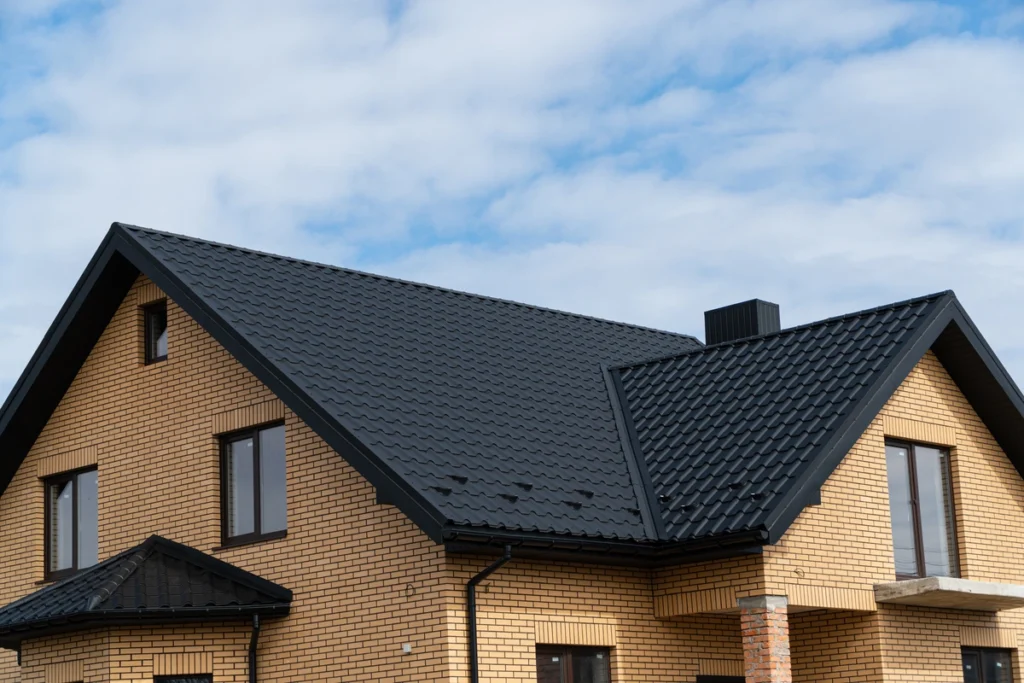 brick house with a dark metal roof
