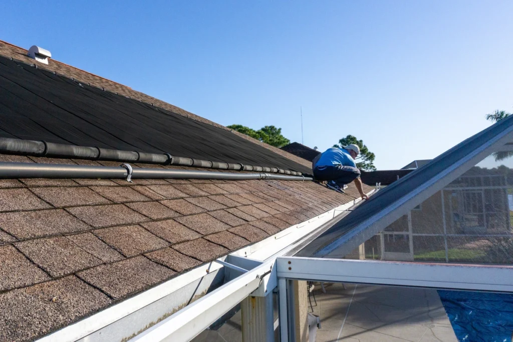 homeowner inspecting his house roof