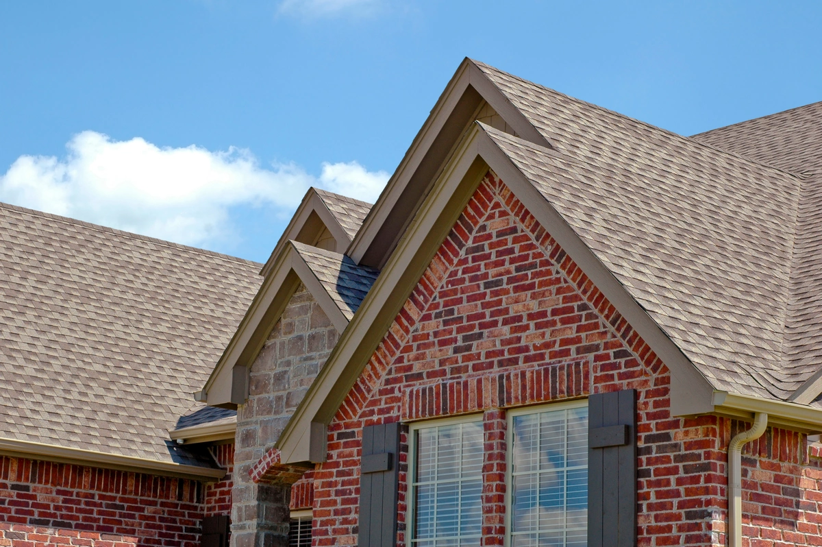 brick house with a shingle roof 1